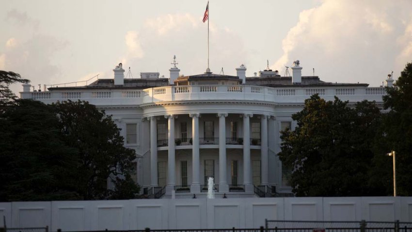 The White House stands behind fencing in Washington, D.C., U.S. on Sunday, Aug. 9, 2020. Trump announced four executive actions on Saturday, including a temporary payroll tax deferral for some workers and continued expanded unemployment benefits, as the coronavirus pandemic continues to hobble the U.S. economy. Photographer: Stefani Reynolds/Bloomberg via Getty Images