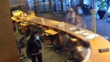 Video image shows stabbing suspect behind MoMA reception desk attacking two employees.