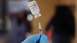 FILE - A pharmacist prepares to administer a COVID-19 vaccine booster at the Southwest Senior Center on Sept. 9, 2022, in Chicago.