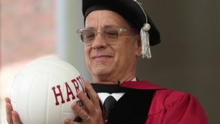 Actor Tom Hanks examines a ball