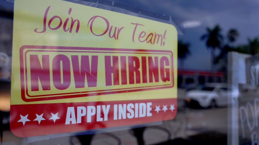 A ‘Now Hiring’ sign posted outside of a restaurant looking to hire workers on May 05, 2023 in Miami, Florida.