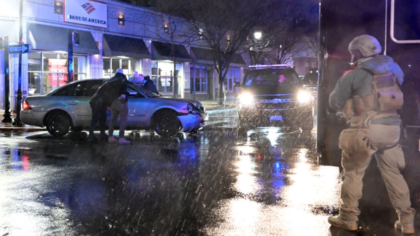 Members of the US Secret Service rush to a car, after it hit a motorcade SUV, as US president Joe Biden was leaving his campaign headquarters in Wilmington, Delaware on December 17, 2023. (Photo by ANDREW CABALLERO-REYNOLDS / AFP) (Photo by ANDREW CABALLERO-REYNOLDS/AFP via Getty Images)