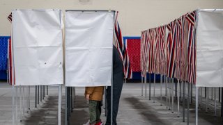 A person casts their ballot in the New Hampshire Primary at Londonderry High School on January 23, 2024