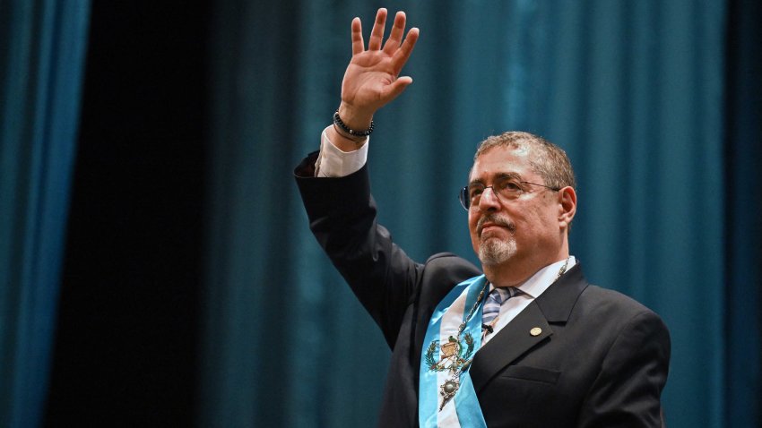 TOPSHOT – Guatemala’s new President Bernardo Arevalo waves after swearing in during his inauguration ceremony at the Miguel Angel Asturias Cultural Centre in Guatemala City, early on January 15, 2024. Bernardo Arevalo was finally sworn in as Guatemala’s president early Monday after the ceremony was delayed for more than nine hours, capping months of judicial machinations to block the anti-corruption crusader from taking office. (Photo by Johan ORDONEZ / AFP) (Photo by JOHAN ORDONEZ/AFP via Getty Images)