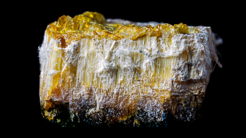 Brick of chrysotile asbestos over black backdrop