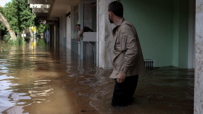 A volunteer looks for people in need of rescue from a flooded area in the Cidade Baixa neighborhood in Porto Alegre, Rio Grande do Sul state, Brazil, on May 8, 2024. The worst natural calamity ever to hit the state of Rio Grande do Sul has claimed at least 95 lives, with 372 people reported injured and 131 still missing, according to the civil defense force that handles disaster relief. (Photo by Anselmo CUNHA / AFP) (Photo by ANSELMO CUNHA/AFP via Getty Images)