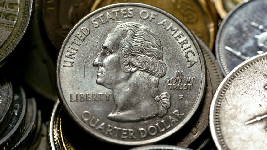 American one quarter coin with other countries different coins background, quarter dollar is a United States coin worth 25 cents with  the profile of George Washington on its obverse, selective focus.