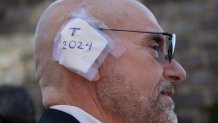 A delegate wears an imitation ear bandage during the Republican National Convention (RNC) outside the Fiserv Forum in Milwaukee, Wisconsin, US, on Wednesday, July 17, 2024. The RNC chairman warned against complacency when his party concludes its official nominating jamboree this week with polls predicting ex-President Donald Trump prevailing over President Joe Biden in the November election. Photographer: Vincent Alban/Bloomberg via Getty Images