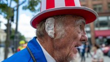 MILWAUKEE, WISCONSIN - JULY 17: A Donald Trump supporter and performer places a bandage over his ear in reference to Trump's wound at the Republican National Convention (RNC) on the third day of the convention on July 17, 2024 in Milwaukee, Wisconsin. Security throughout downtown Milwaukee remains high following the assassination attempt on former President Donald Trump over the weekend. Thousands of delegates, politicians and the Republican faithful are arriving into the traditionally Democratic city over the next few days for the annual convention which will conclude with former President Donald Trump accepting his party's presidential nomination. The RNC takes place from July 15-18.  (Photo by Spencer Platt/Getty Images)