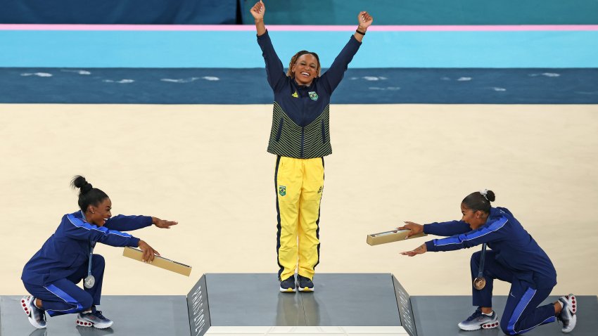 Gold medalist Rebeca Andrade (C) of Team Brazil, silver medalist Simone Biles (L) of Team United States and bronze medalist Jordan Chiles (R) of Team United States celebrate on the podium at the Artistic Gymnastics Women's Floor Exercise Medal Ceremony on day ten of the Olympic Games Paris 2024 at Bercy Arena on August 05, 2024 in Paris, France. (Photo by Elsa/Getty Images)