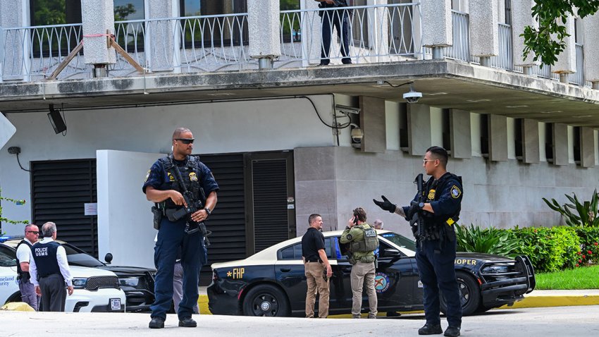 Department of Homeland Security police officers and other law enforcement officials stand watch outside the Paul G. Rogers Federal Building and US Courthouse during a hearing on the detention of Ryan Wesley Routh, suspected of the attempted assassination of former US president Donald Trump, in West Palm Beach, Florida, on September 23, 2024. Routh was detained after fleeing Trump’s club in West Palm Beach where the former president was playing golf on September 15 when Secret Service agents discovered a rifle barrel sticking out from a treeline and opened fire on the suspect. (Photo by Giorgio VIERA / AFP) (Photo by GIORGIO VIERA/AFP via Getty Images)