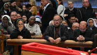 Faithful react next to the coffin as they pay their respects to late Pope Francis inside St Peter’s Basilica in The Vatican, on April 24, 2025. The Vatican said on April 24, 2025, that nearly 50,000 people had so far paid their respects to Pope Francis, whose body is lying in state at St Peter’s Basilica for three days before his funeral. (Photo by Andreas SOLARO / AFP) (Photo by ANDREAS SOLARO/AFP via Getty Images)