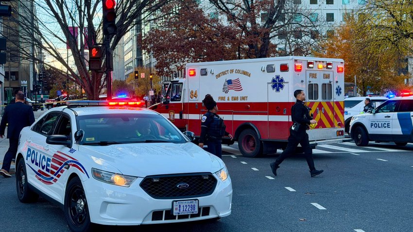 Police and first responders gather near a crime scene after a shooting in downtown Washington, DC, on November 26, 2025. Two members of the National Guard were shot Wednesday just blocks from the White House, according to officials, as a spokesperson for Donald Trump said the president has been briefed on the "tragic situation." Police said they had detained a suspect. (Photo by Daniel SLIM / AFP via Getty Images)