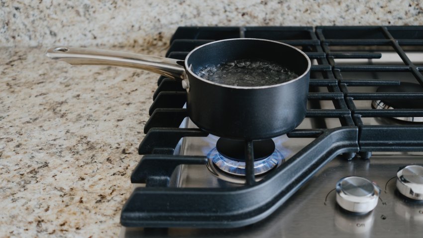 Close-up of water boiling on gas cooktop