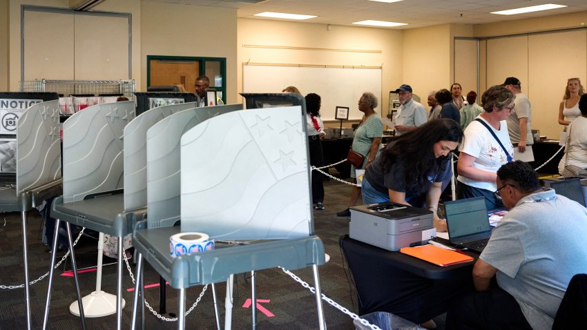 People stand in line to cast their ballot at the Knightdale Recreation Center on the first day of early voting in Knightdale, North Carolina on October 15, 2026. Americans voting in the November 3 midterm elections will decide who controls Congress for the final two years of Donald Trump’s presidency, along with dozens of governorships and thousands of state offices. (Photo by Matt RAMEY / AFP via Getty Images)